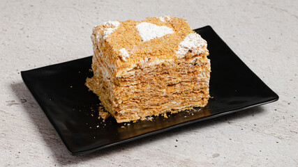 Cake slice on black tray 