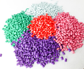 Various colors of masterbatch granules isolated on white background, polymer carriers of color pigments in the plastics industry