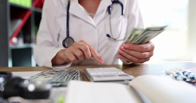 Doctor hand holds cash and counts money on calculator. Financial income of physicians and medical bribe