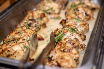 Coconut cream chicken, baked and served at an event in catering buffet dish