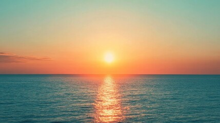 Fototapeta premium Ocean horizon glowing with teal and orange hues as the sun sets, creating a beautiful and serene end to the day