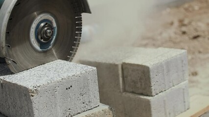Paving slabs are cut with a grinder