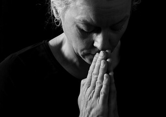 praying with hand on bible learning christianity and the faith of God with people stock image stock photo	