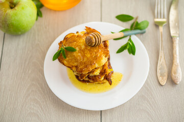 fried pancakes with apples and honey