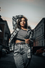 Girl with Coffee Against the Night City Background