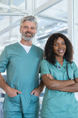 Obraz premium Two doctors looking contented and confident while standing in the hospital corridor