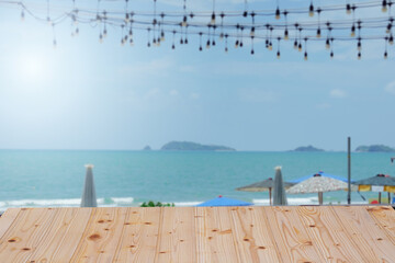 Coastal dining scene with a wooden table and a calm ocean view, ideal for tranquil outdoor dining experiences