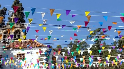 View of Vilaflor mountain village with multicolored triangular small flags to holiday celebration in Tenerife, Canary islands, Spain.Travel concept.