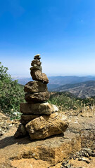 A tower of stones on Mount Olympos. Cyprus, June 2024. View from the mountains