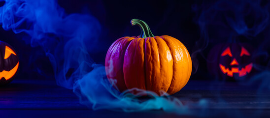 whole pumpkin with a green stem sits on a wooden surface with blue lights smoke