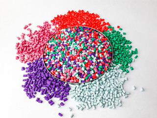 Various colors of masterbatch granules isolated on white background, polymer carriers of color...