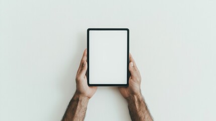 Man holding a tablet on solid grey background. Tablet mockup display for technology, website, landing page, app, ipad, social media, blog, advertisement. Blank white screen. 