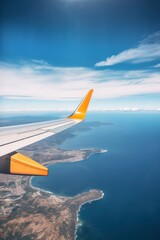 Wing of an airplane flying above the sea. View from airplane window