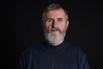 Obraz premium Portrait of senior man on black background