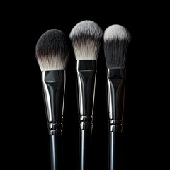 Make-up brushes with powder isolated on black background