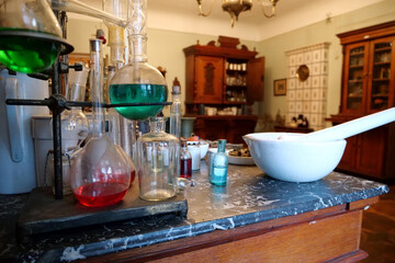 Chemistry beakers, bottles and flasks with liquids in laboratory