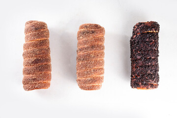 Traditional East Europe Christmas sugar glazed dessert chimney cake, trdlo or trdelnik, sweet aromatic winter seasonal street food with cinnamon and spices