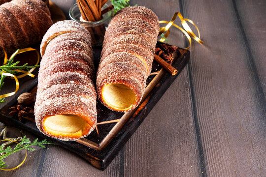 Traditional East Europe Christmas sugar glazed dessert chimney cake, trdlo or trdelnik, sweet aromatic winter seasonal street food with cinnamon and spices