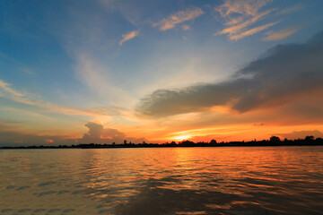 Fototapeta premium Riverbank landscape with sky and sunset