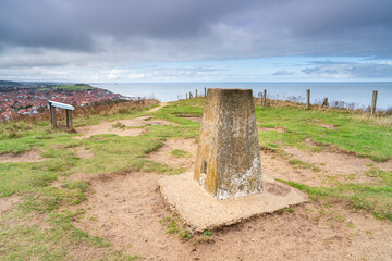 Trig point or Triangulation point at the summit of Beeston Hill in Sheringham, Norfolk, UK in...