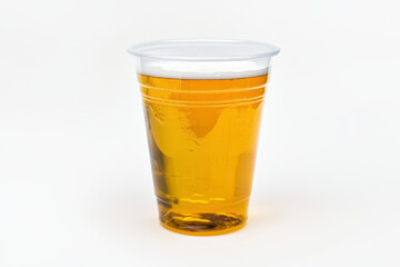transparent plastic cup filled with beer on white background,