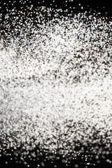 Abstract black and white background of pouring flour, space for text