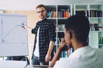 Man drawing diagram for colleague