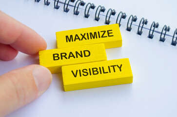 Maximize Brand Visibility text on yellow wooden blocks. Branding visibility concept.
