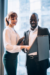Cheerful coworking business people with file
