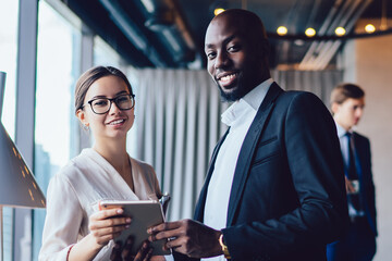 Confident young business people with tablet