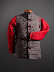 Historical fashion. Medieval knight cloth. Padded jacket gambeson.