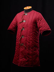 Historical fashion. Medieval knight cloth. Padded jacket gambeson.