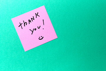 A handwritten thank you note on a colorful background expressing gratitude and positivity