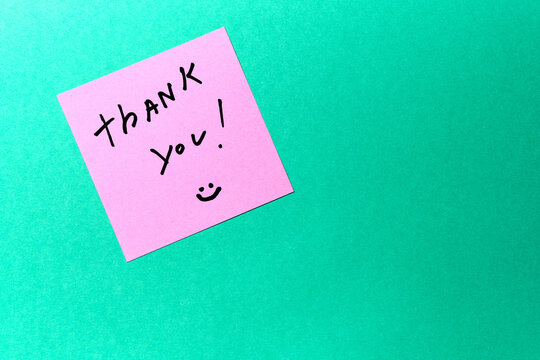 A handwritten thank you note on a colorful background expressing gratitude and positivity