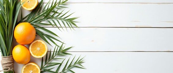 Green willow branches, palm branches, citrus fruits on a white wooden background. The concept of the Sukkot holiday. A copy space. top view