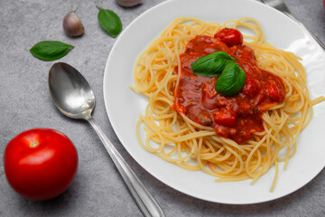 Flat Lay of Delicious Spaghetti Napoli with Fresh Tomatoes, Garlic, and Basil