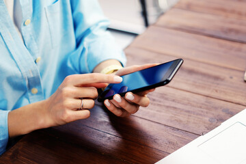 Woman pointing on smartphone screen, chatting in social networks, meeting website, searching internet, sending sms, using text messenger or online banking