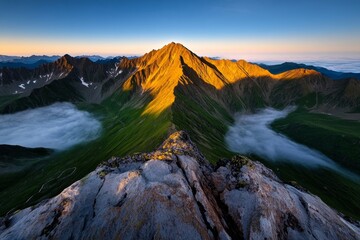 A breathtaking panorama of a mountain range at sunrise, with the peaks glowing in golden light, and valleys covered in mist, capturing the serene beauty of nature