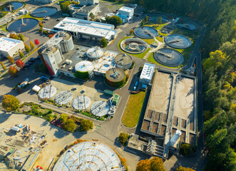 A view of a water treatment plant with many tanks and pipes