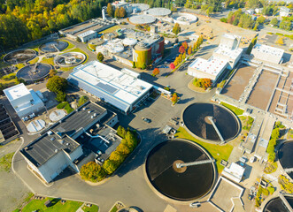 A view of a water treatment plant with a large circular tank in the center