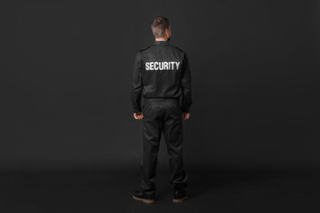 Security guard in uniform on black background, back view