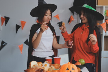 friendship, holiday and people concept - group of happy smiling friends in halloween costumes of...