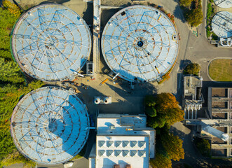 A view of a large industrial area with three large tanks in the foreground