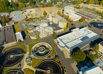 A view of a water treatment plant with a large circular building in the center