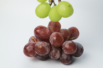 Red grapes and green grapes on a gray background