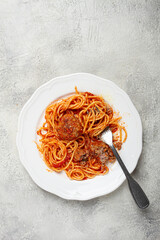 spaghetti with meatballs in tomato sauce, on a white plate, no people, homemade,