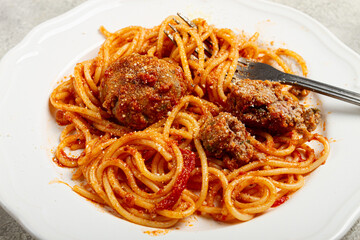 spaghetti with meatballs in tomato sauce, on a white plate, no people, homemade,