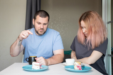 Family dinner, husband and wife drinking coffee and eating cake at home, relaxing with gourmet pastry and drinks, a joyful meal indoors, sharing a quiet moment.