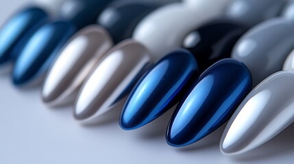 A detailed shot of nails with a matte finish in muted blue and grey shades, shiny metallic accents creating a modern geometric design, glossy and matte contrast captured under soft studio lighting,