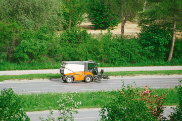 Road sweeper driving down empty highway